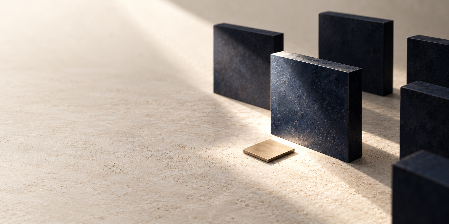 White light reveals one navy stone panel among several, with a single gold square on the pale limestone surface.